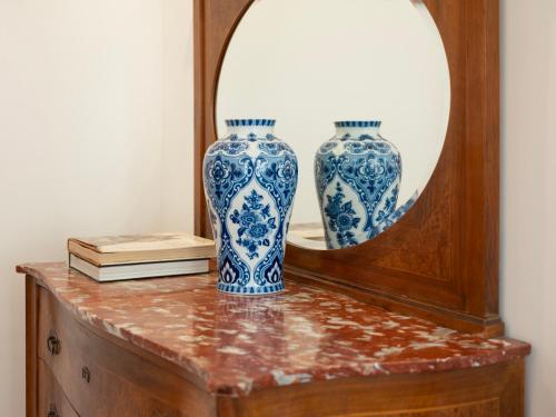 two blue and white vases on a table in front of a mirror at Borgia di Firenze in Florence