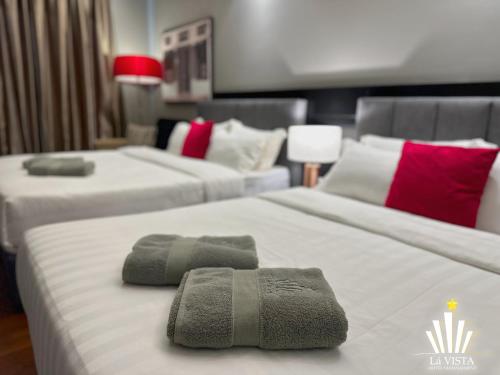 a hotel room with two beds with towels on them at The Shore Hotel & Residences By Lá VISTA in Melaka
