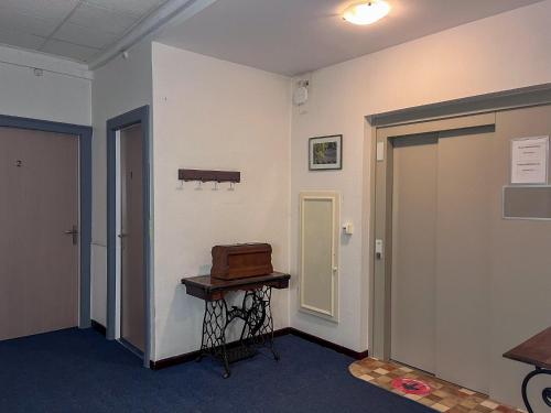an empty room with a door and a table in it at Le National Sète Centre Gare,Ascenseur in Sète