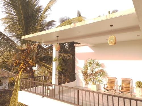a balcony of a house with palm trees at COCO Rooms in Galle