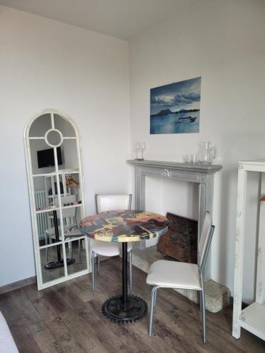 a room with a table and chairs and a fireplace at Le Camere Della Vecchia Osteria in Stresa