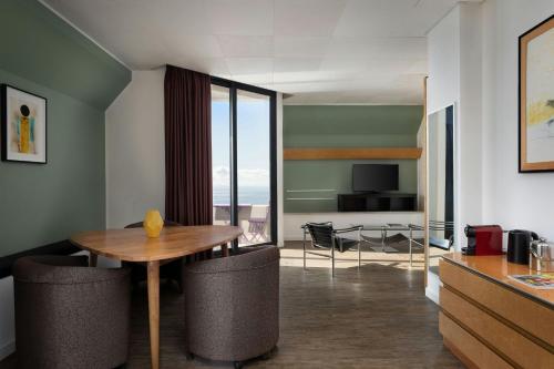 a dining room with a table and a view of the ocean at Four Points by Sheraton Catania Hotel in Catania
