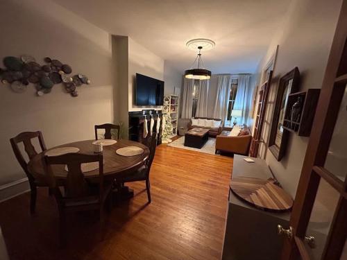 a living room with a dining room table and a couch at Heart of Midtown Home on Penn St - Pet Friendly in Harrisburg