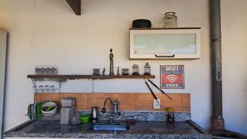 a kitchen with a sink and a counter top at Casa De Praia Baptista Resort Jacaraípe in Serra