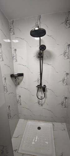 a bathroom with a sink and a white wall at Chambres d'Hôtes Centre Ville in Dakar