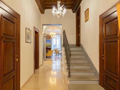 a hallway with stairs and a chandelier at Borgia di Firenze in Florence