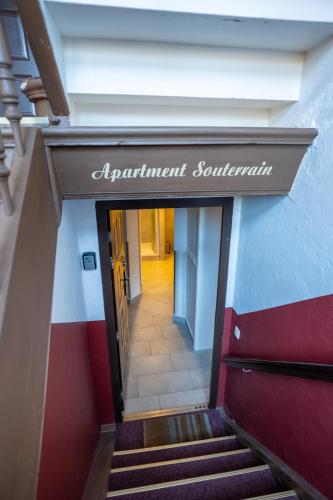 a stairway with a sign that reads apartment sanitation at Villa Backstein OBO19 in Schwerin
