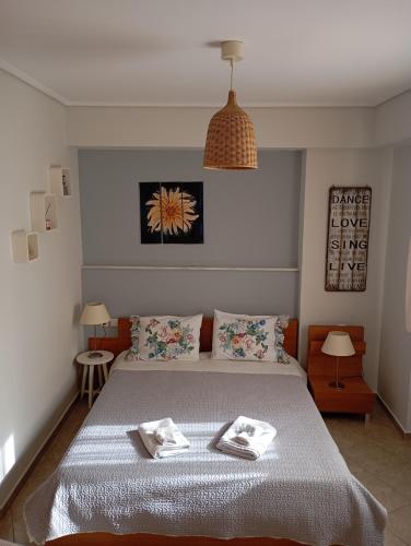 a bedroom with a bed with two towels on it at Volos Seaside Studio in Volos