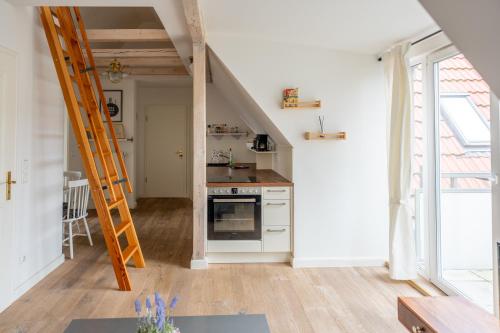 a kitchen with a stove and a ladder in a room at Villa Backstein OBO19 in Schwerin