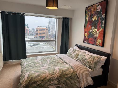 a bedroom with a bed and a large window at Harrow Town Centre Apartment in Harrow