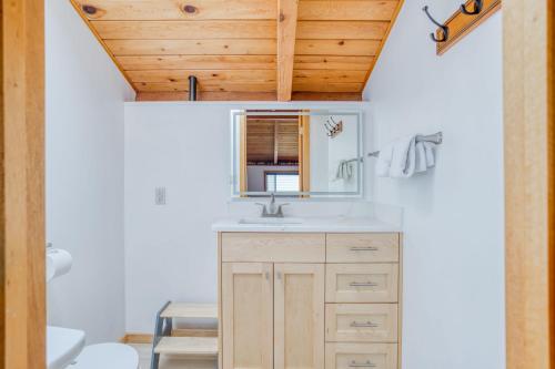 a bathroom with a sink and a wooden ceiling at Play Chalet MCA 489 - Meredith Lodging in Manzanita