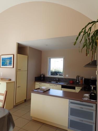 a kitchen with a counter and a sink and a window at Holiday Home Lochrist Le Conquet in Le Conquet