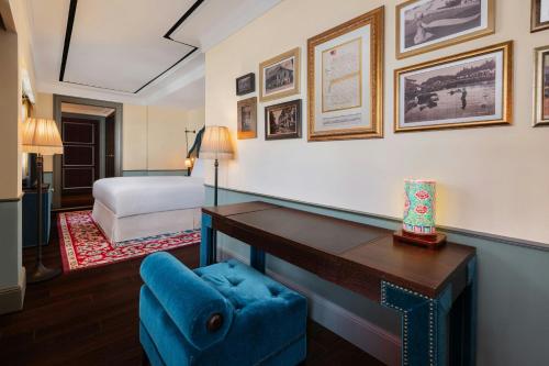 a hotel room with a desk and a bed at Maxwell Reserve Singapore, Autograph Collection in Singapore