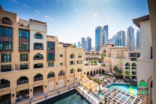 an overhead view of a building with a pool and a city at Souk Al Bahar - Burj Khalifa - Dream View Holiday Home Rental in Dubai