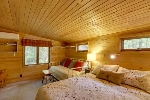 a bedroom with a bed and a couch in a room at Quiet Deer River Cabin with Dock and Lake View! in Deer River