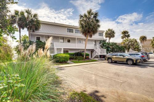 a apartment building with cars parked in a parking lot at Condo on St Johns River with Boat Dock Access! in Welaka