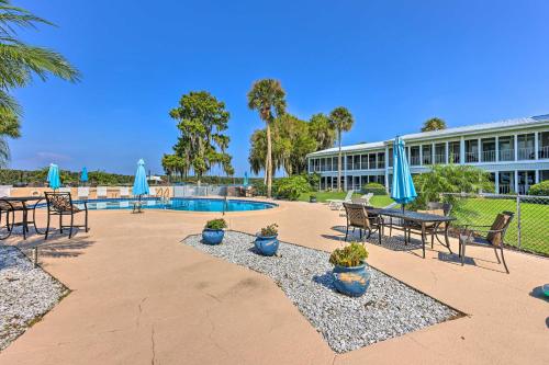 a resort with a pool and chairs and umbrellas at Condo on St Johns River with Boat Dock Access! in Welaka