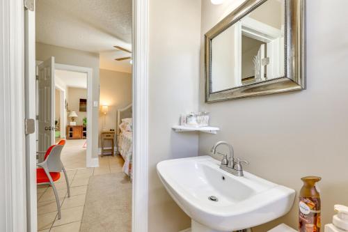 a bathroom with a sink and a mirror at 14 Mi to Raleigh Charming Family Home! in Cary