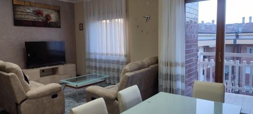 a living room with a table and chairs and a television at Molise Rigenera in Isernia