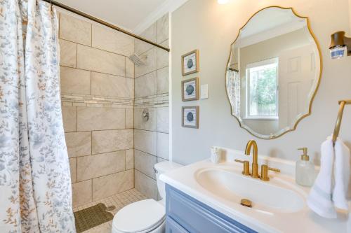 a bathroom with a sink and a toilet and a mirror at 2 Mi to Shore Modern Retreat in Fort Walton Beach in Fort Walton Beach