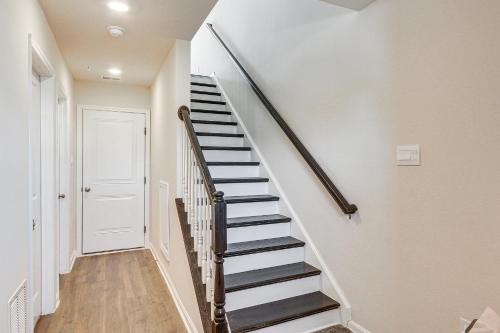 a staircase in a home with white walls and wooden floors at 2 Mi to Dtwn Frederick Updated Townhome in Frederick