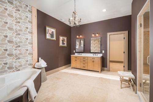 a bathroom with a tub and a sink at Group Getaway! 8,000-Sq-Ft Gem, Arcade + Theater in Beech Mountain