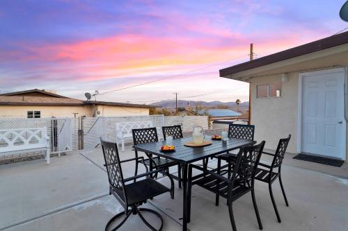 a black table and chairs on a patio at 6 Mi to Joshua Tree Home with Outdoor Oasis and View! in Twentynine Palms