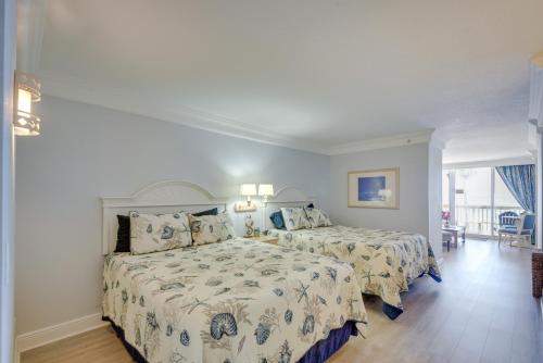 a bedroom with two beds and a large window at Daytona Beach Studio Condo with Ocean Views! in Daytona Beach