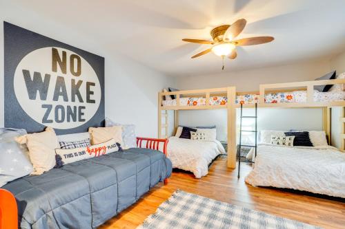 a room with two bunk beds and a ceiling fan at Lakefront Home with Private Dock in Grove in Grove