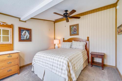 a bedroom with a bed and a ceiling fan at Deck and Fire Pit! Cabin Half-Mi to Tunica Lake in Tunica