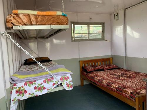 a bedroom with a bed and a swing at Wild woods in Vālpārai