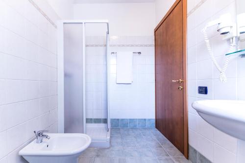 a bathroom with a sink and a toilet and a shower at Hotel Sporting in Casarsa della Delizia