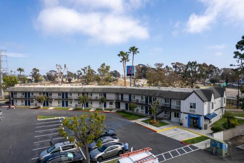 an apartment building with cars parked in a parking lot at Motel 6-San Diego, CA - North in San Diego