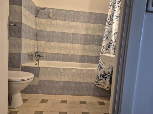 une salle de bain avec une baignoire, des toilettes et un lavabo dans l'établissement Le Grand Sud, à Nice
