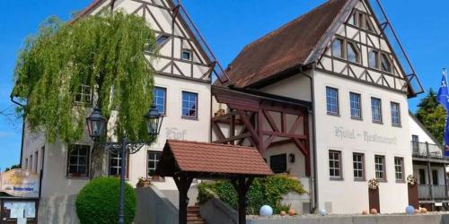 a large white building with a brown roof at Landhotel Neukirchner Hof in Neukirchen bei Sulzbach-Rosenberg