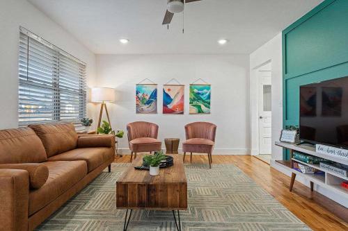 a living room with a couch and a tv at MTB Haven Minutes to Coler and Downtown in Bentonville