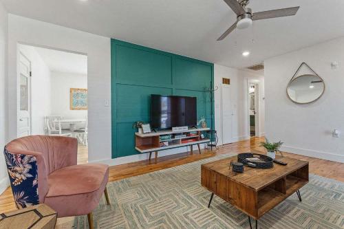 a living room with a coffee table and a tv at MTB Haven Minutes to Coler and Downtown in Bentonville