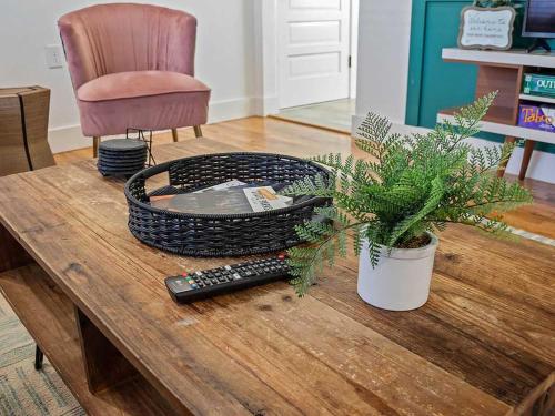 a table with a remote control and a plant on it at MTB Haven Minutes to Coler and Downtown in Bentonville