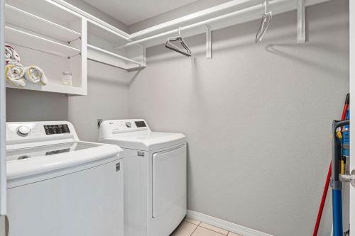 a small laundry room with a washer and dryer at Coler House Cyclist Retreat with Hot Tub in Bentonville