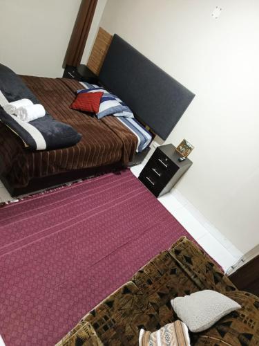 a bedroom with two beds and a purple rug at Casa Mirador guesthouse in Cusco