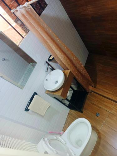 a bathroom with a toilet and a sink at Casa Mirador guesthouse in Cusco