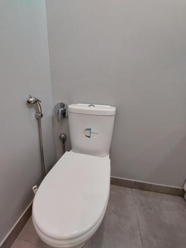 a bathroom with a white toilet in a room at Студія поряд з замком Любарта in Luts'k