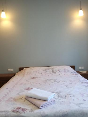 a bed with two towels on top of it at Студія поряд з замком Любарта in Luts'k