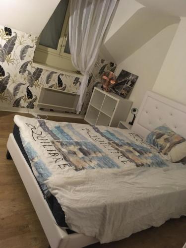 une chambre avec un lit blanc dans une pièce dans l'établissement Charmant appartement Centre ville, à Orléans