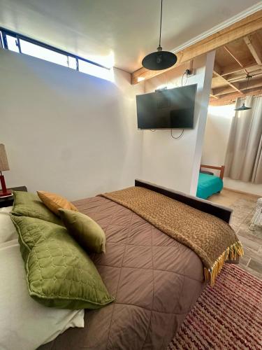 a bedroom with a large bed with a flat screen tv at Doña Patty in El Tabo