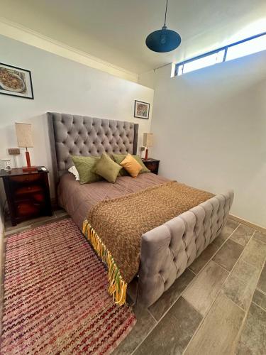 a bedroom with a large bed with a large headboard at Doña Patty in El Tabo