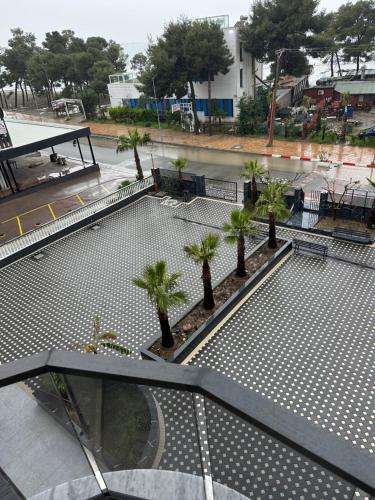 a swimming pool with palm trees on a building at Molla Hotel Restorant in Shëngjin