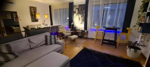 a living room with a couch and a table at ArtApartment near Stephansplatz Stylish 2 Bedroom with AC in Vienna