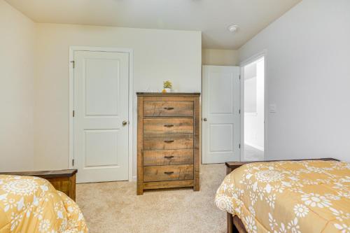 a bedroom with two beds and a wooden dresser at 9 Mi to Old Salem Spacious Family Home with Yard! in Winston-Salem