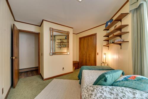 a small room with two beds and a closet at Near Canandaigua Lake Retro Cabin with Deck and Views in Naples